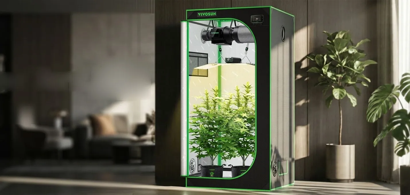 A Vivosun grow tent set up in a living space, lit and running with plants inside